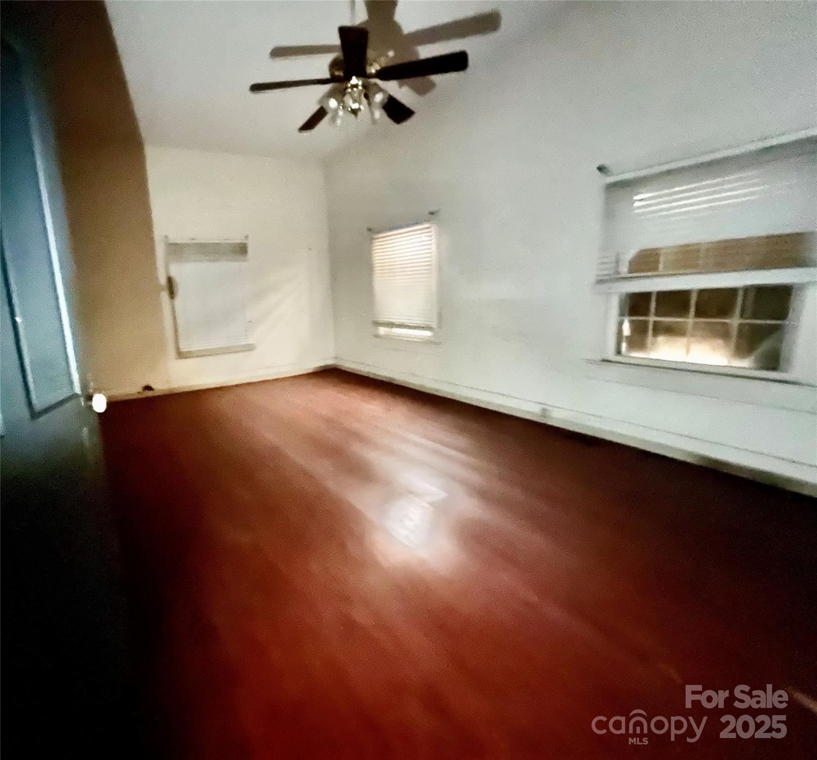 407 Chester Avenue Great Falls, SC 29055 - Photo 23 of 42 an empty room with wooden floor and windows