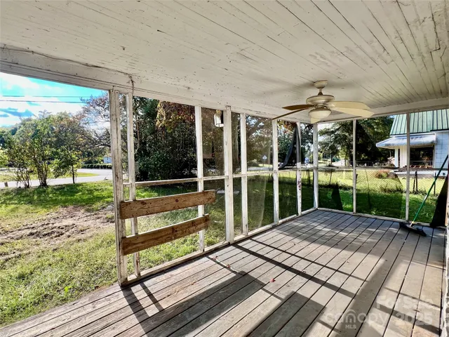 a view of a patio with a table chairs and a yard