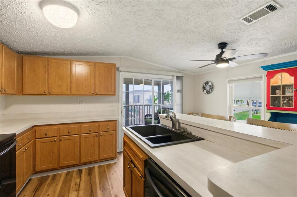 15 North Cardinal, Unit B15 Punta Gorda, FL 33950 - Photo 12 of 49 a kitchen that has a sink and a stove with wooden floor