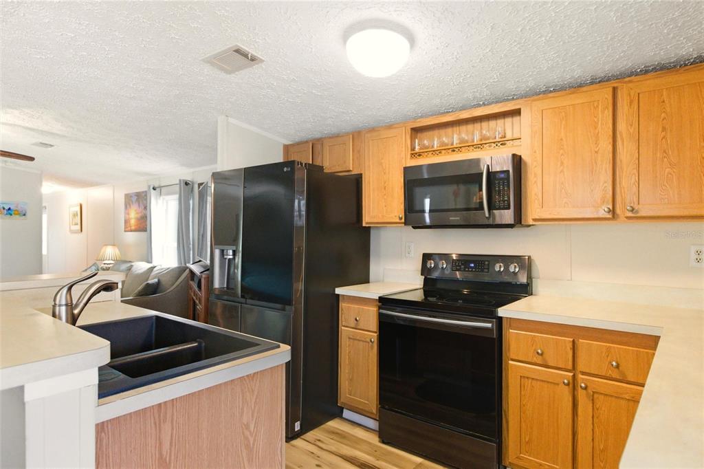 15 North Cardinal, Unit B15 Punta Gorda, FL 33950 - Photo 13 of 49 a kitchen with stainless steel appliances a refrigerator stove and microwave