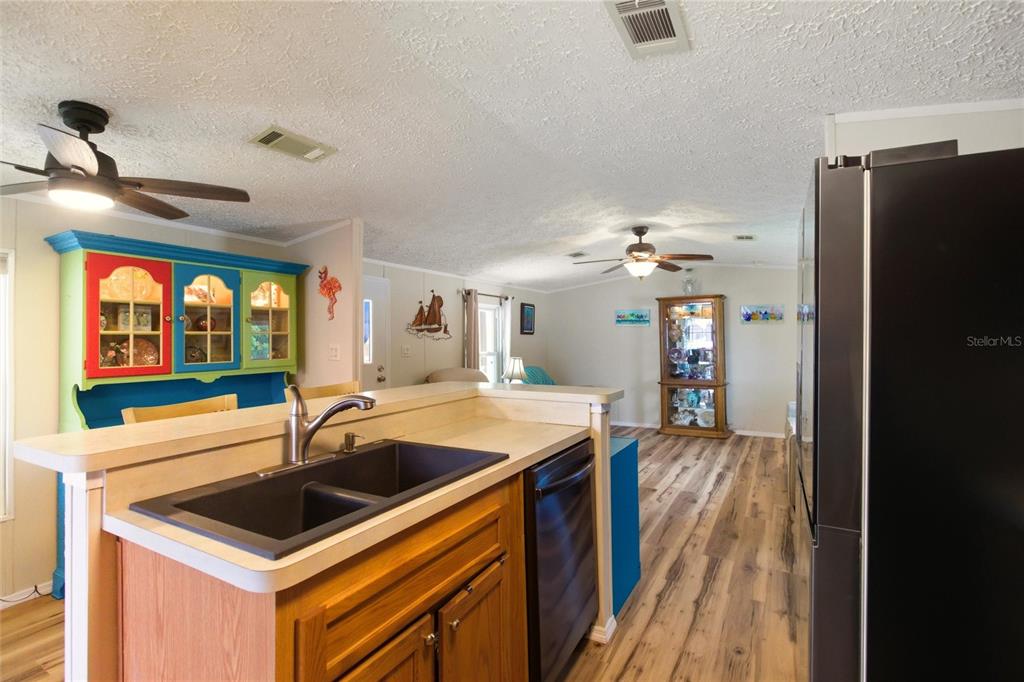 15 North Cardinal, Unit B15 Punta Gorda, FL 33950 - Photo 14 of 49 a kitchen with a sink a counter top space and stainless steel appliances