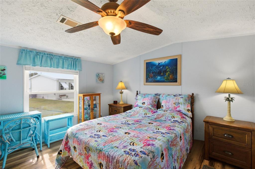 15 North Cardinal, Unit B15 Punta Gorda, FL 33950 - Photo 17 of 49 a bedroom with a bed and a chandelier