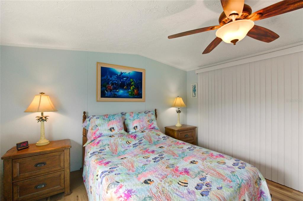 15 North Cardinal, Unit B15 Punta Gorda, FL 33950 - Photo 20 of 49 a bedroom with a bed and a lamp on dresser