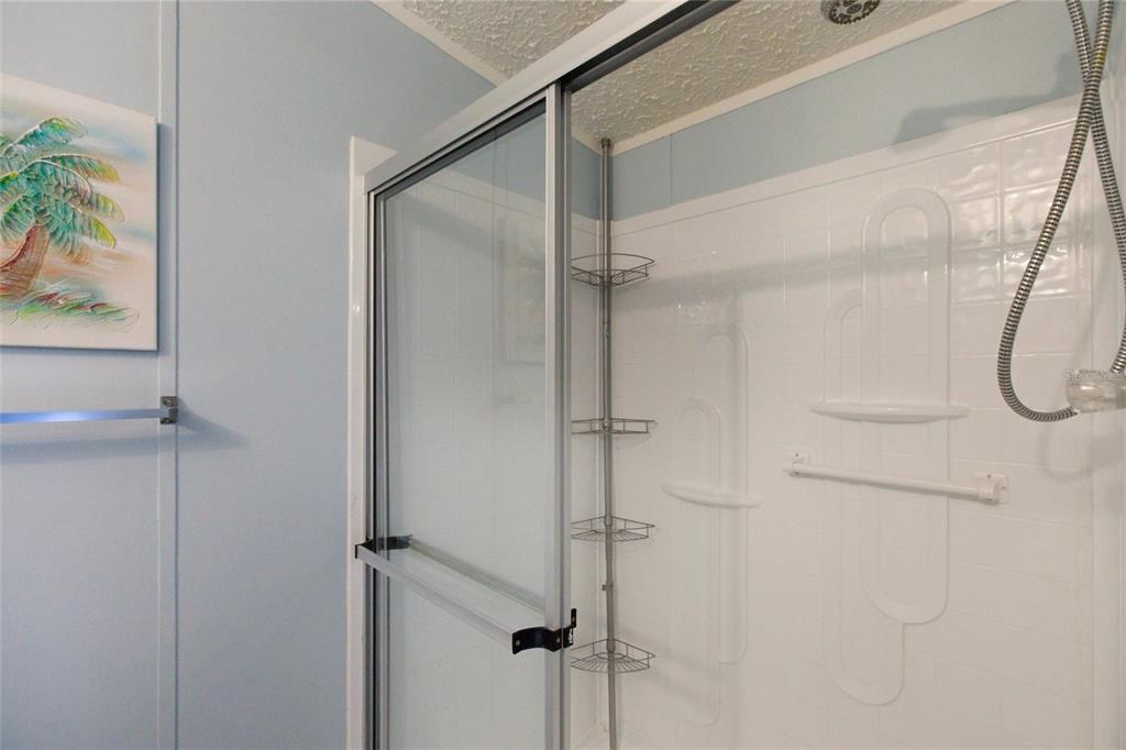 15 North Cardinal, Unit B15 Punta Gorda, FL 33950 - Photo 22 of 49 a bathroom with a glass shower door and a window