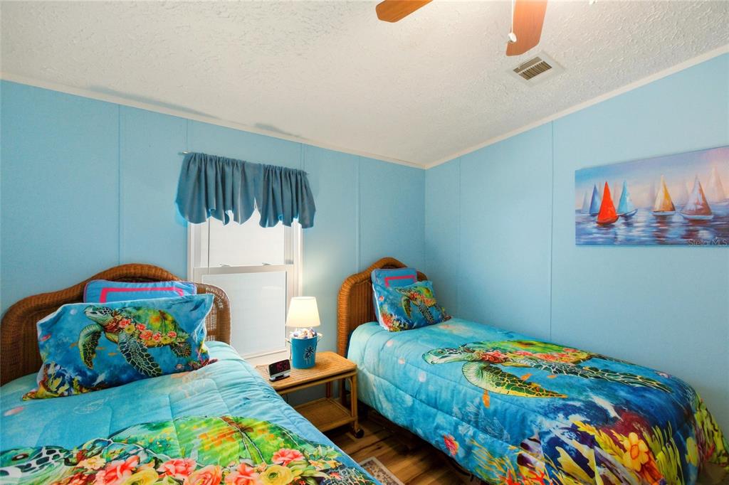 15 North Cardinal, Unit B15 Punta Gorda, FL 33950 - Photo 24 of 49 a bedroom with two beds and a painting on the wall