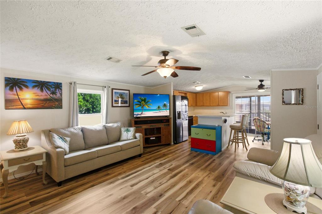 15 North Cardinal, Unit B15 Punta Gorda, FL 33950 - Photo 8 of 49 a living room with fireplace furniture and a wooden floor