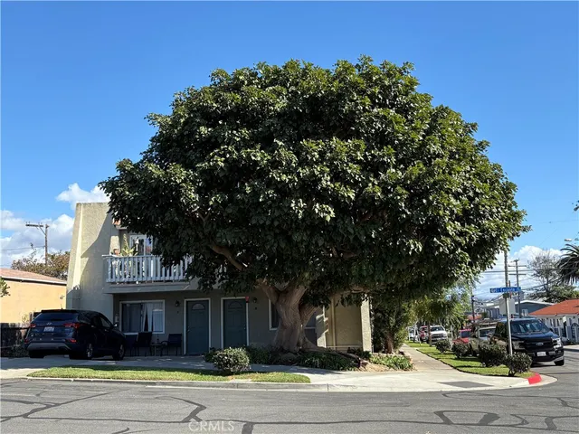 a front view of a building with trees