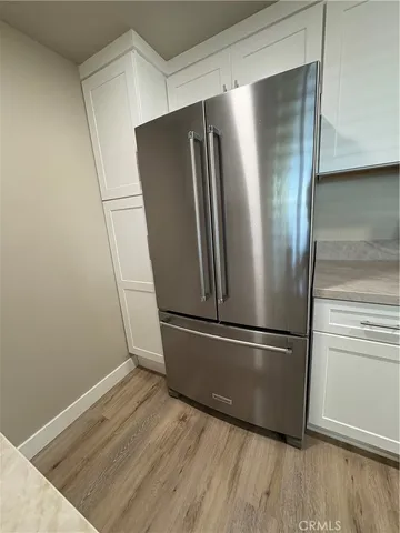 a metallic refrigerator freezer sitting in a kitchen