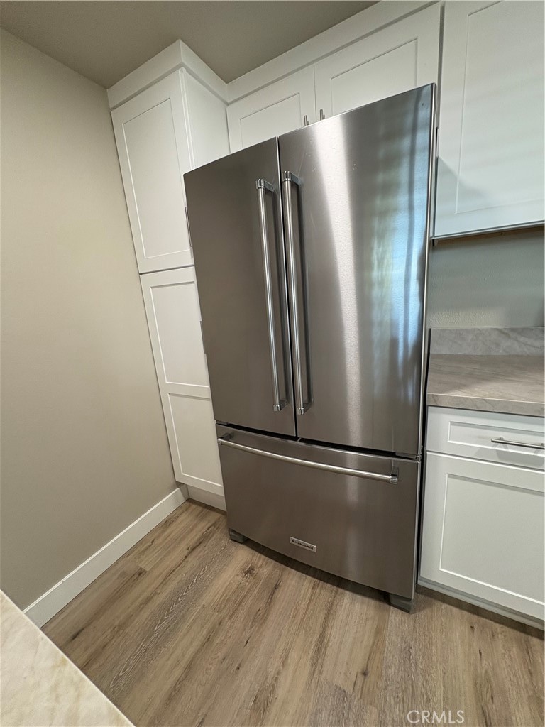 33972 El Encanto Avenue, Unit D Dana Point, CA 92629 - Photo 11 of 46 a metallic refrigerator freezer sitting in a kitchen
