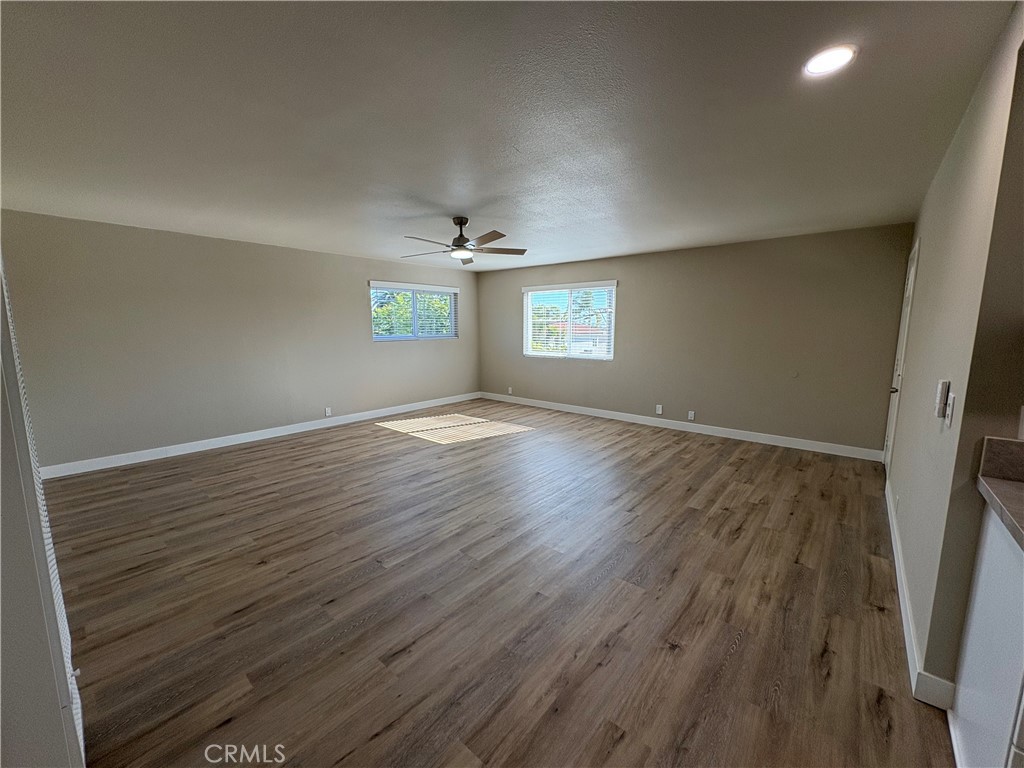33972 El Encanto Avenue, Unit D Dana Point, CA 92629 - Photo 16 of 46 an empty room with wooden floor and windows