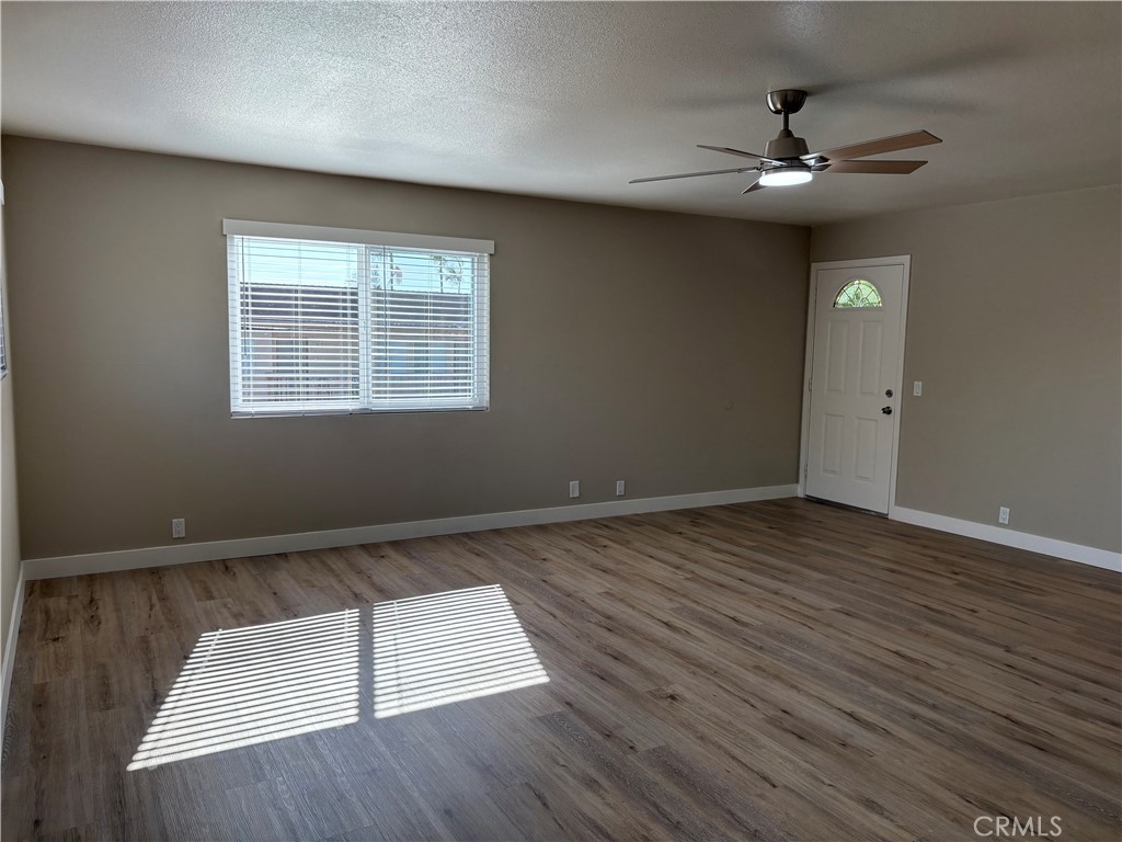 33972 El Encanto Avenue, Unit D Dana Point, CA 92629 - Photo 17 of 46 a view of an empty room with wooden floor and a window
