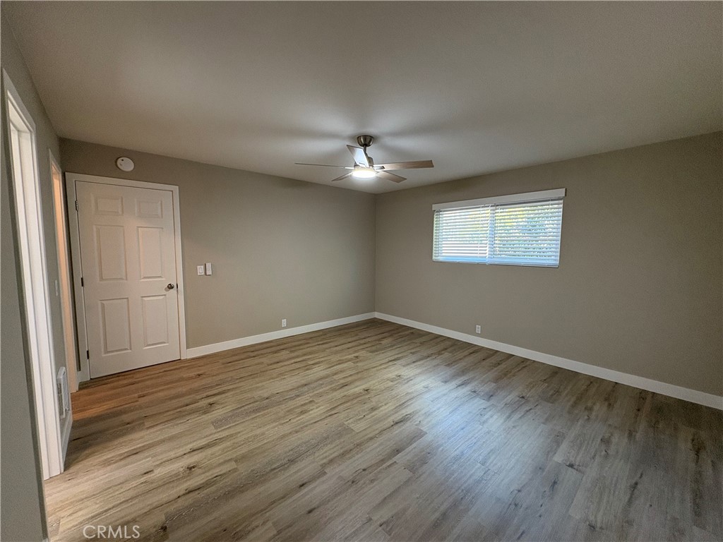 33972 El Encanto Avenue, Unit D Dana Point, CA 92629 - Photo 22 of 46 an empty room with wooden floor and windows