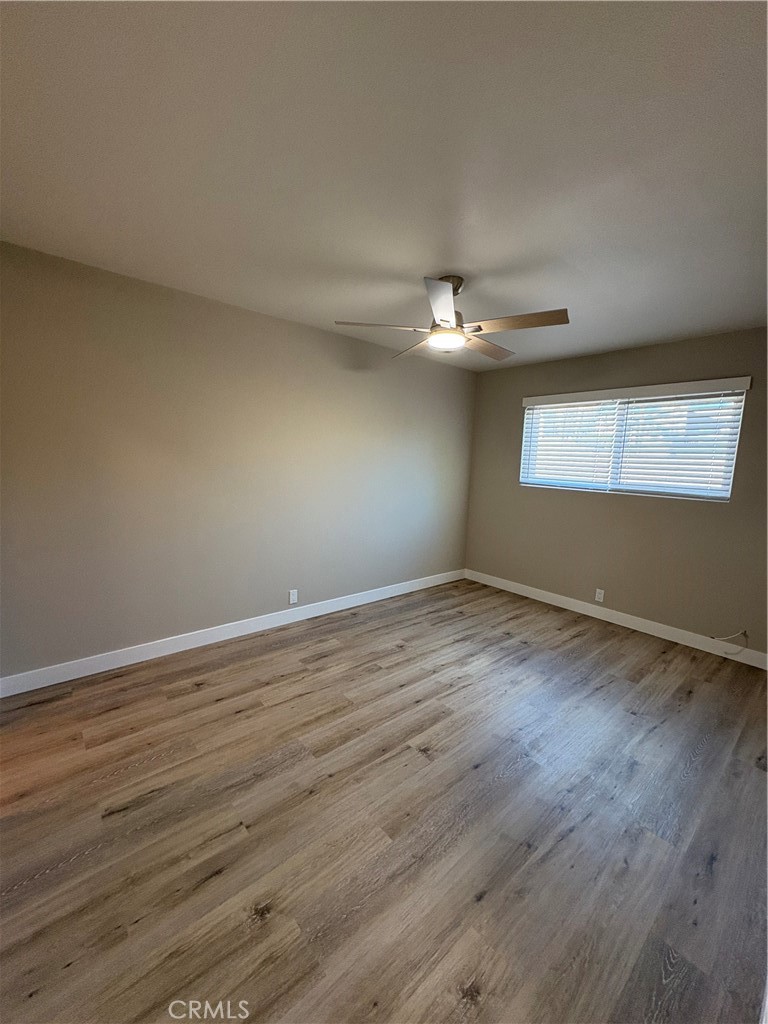33972 El Encanto Avenue, Unit D Dana Point, CA 92629 - Photo 29 of 46 a view of an empty room with wooden floor and a window