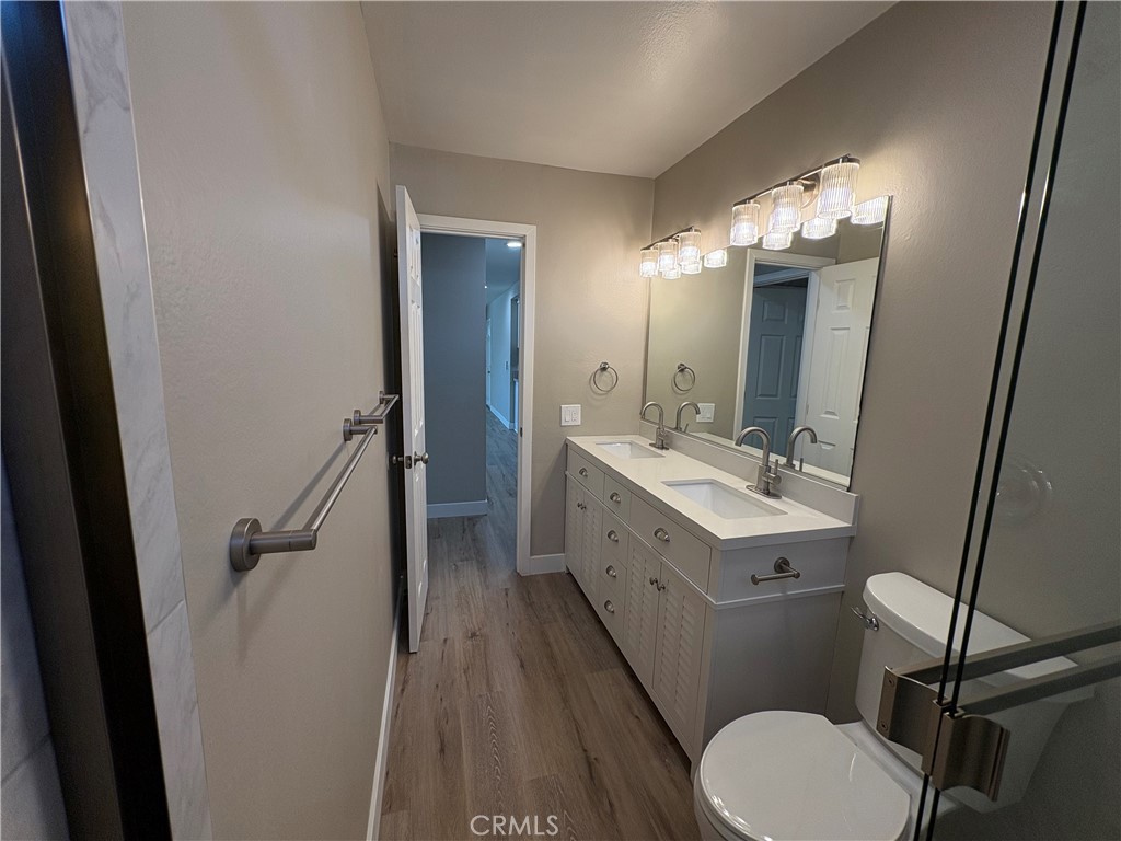33972 El Encanto Avenue, Unit D Dana Point, CA 92629 - Photo 35 of 46 a bathroom with a sink vanity mirror and toilet