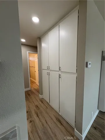 a view of hallway with wooden floor