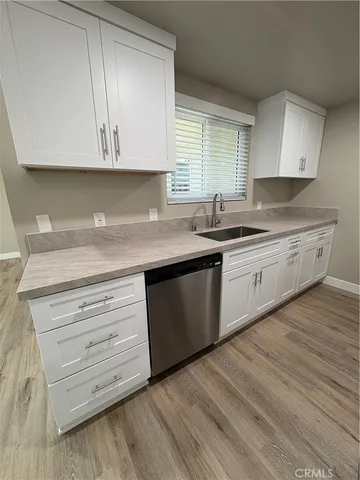 a kitchen with stainless steel appliances granite countertop a sink a stove and cabinets