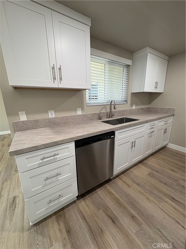 33972 El Encanto Avenue, Unit D Dana Point, CA 92629 - Photo 5 of 46 a kitchen with stainless steel appliances granite countertop a sink a stove and cabinets