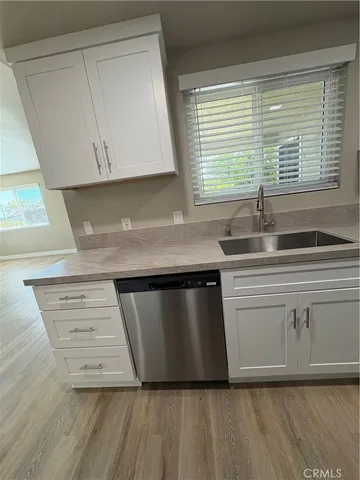 a kitchen with granite countertop a sink and a stove