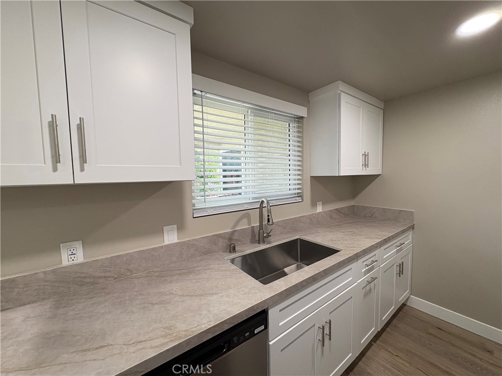 33972 El Encanto Avenue, Unit D Dana Point, CA 92629 - Photo 8 of 46 a kitchen with a sink and cabinets