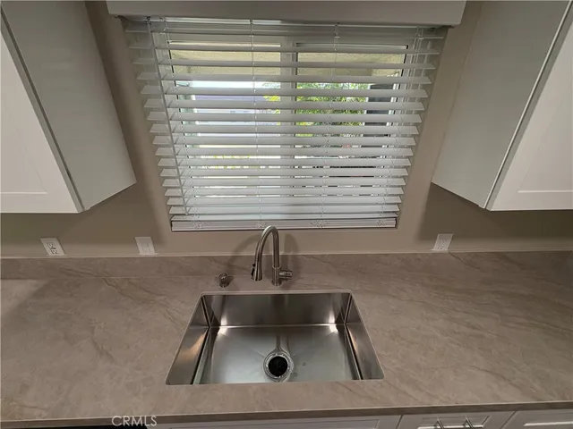 a bathroom with a sink a vanity and a window