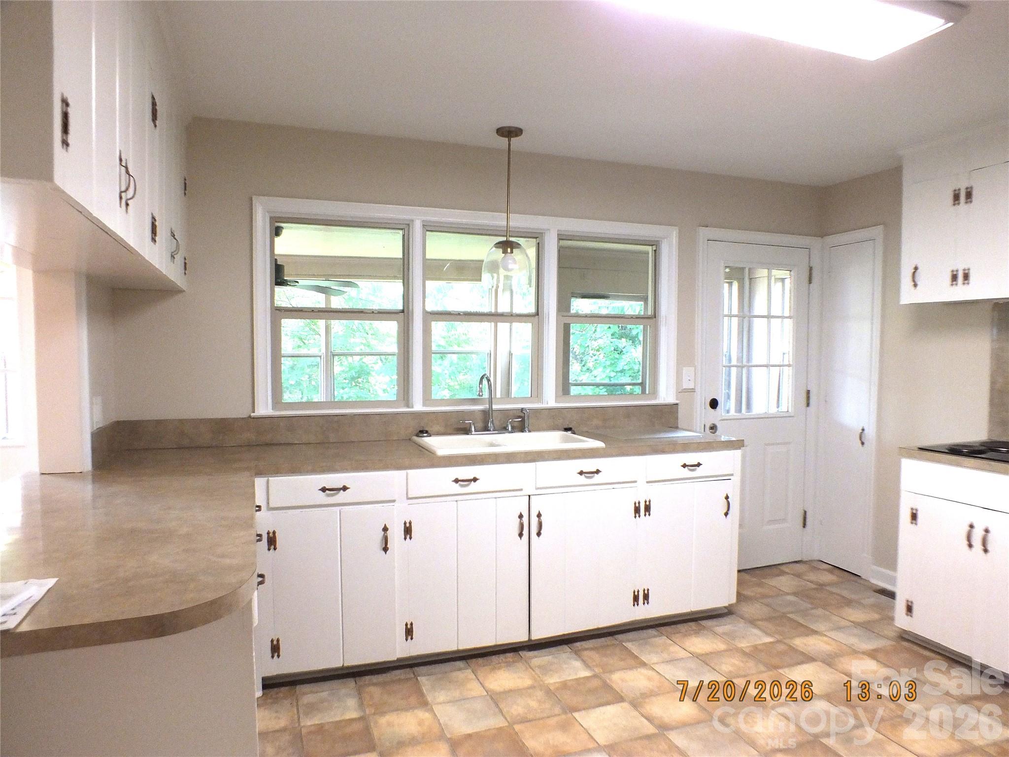 414 West Springs Street Lancaster, SC 29720 - Photo 7 of 22 a kitchen with a sink stove and cabinets