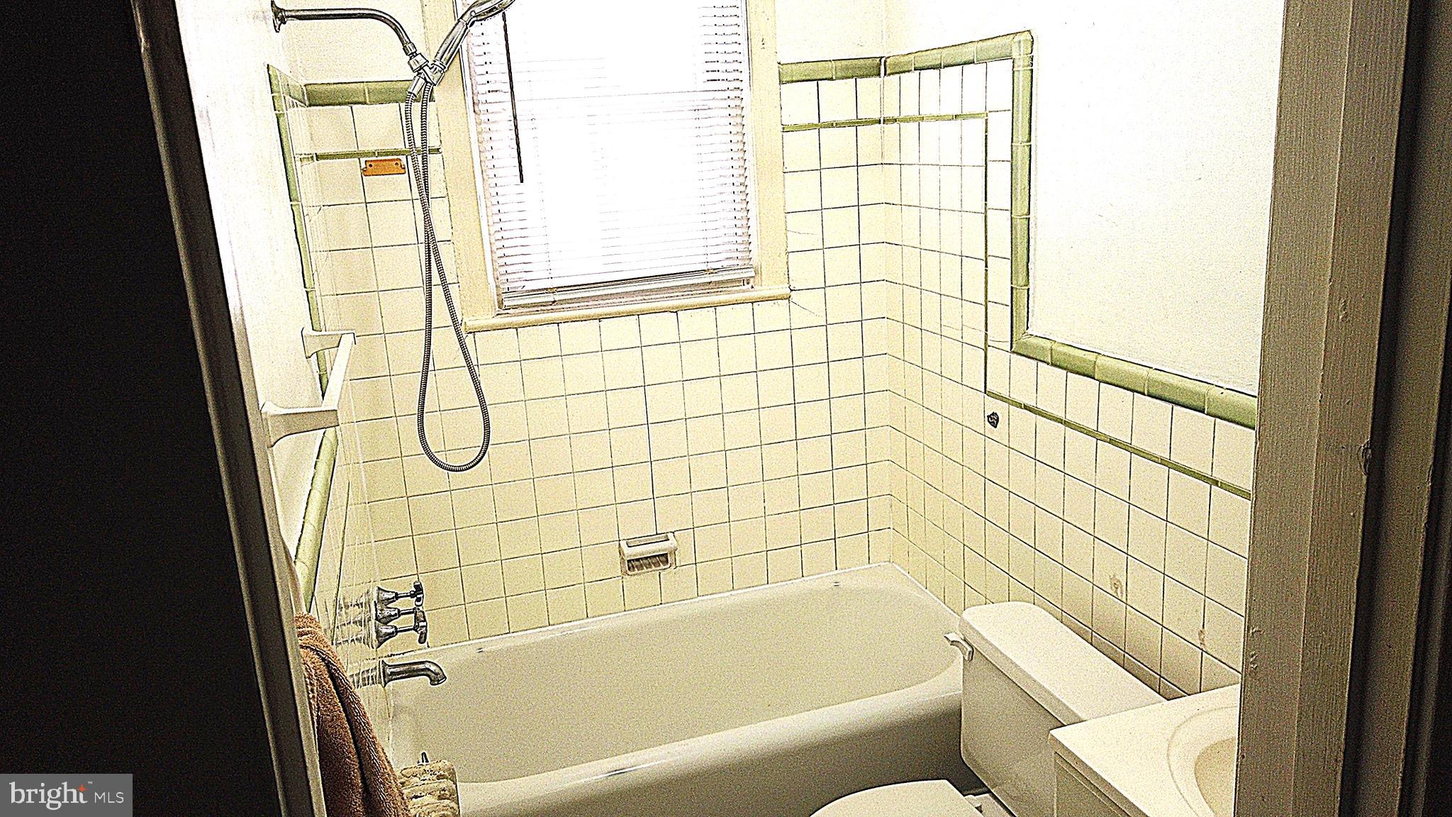 820 Taylor Street Northeast, Unit 3 Washington, DC 20017 - Photo 4 of 9 a bathroom with a bathtub and shower