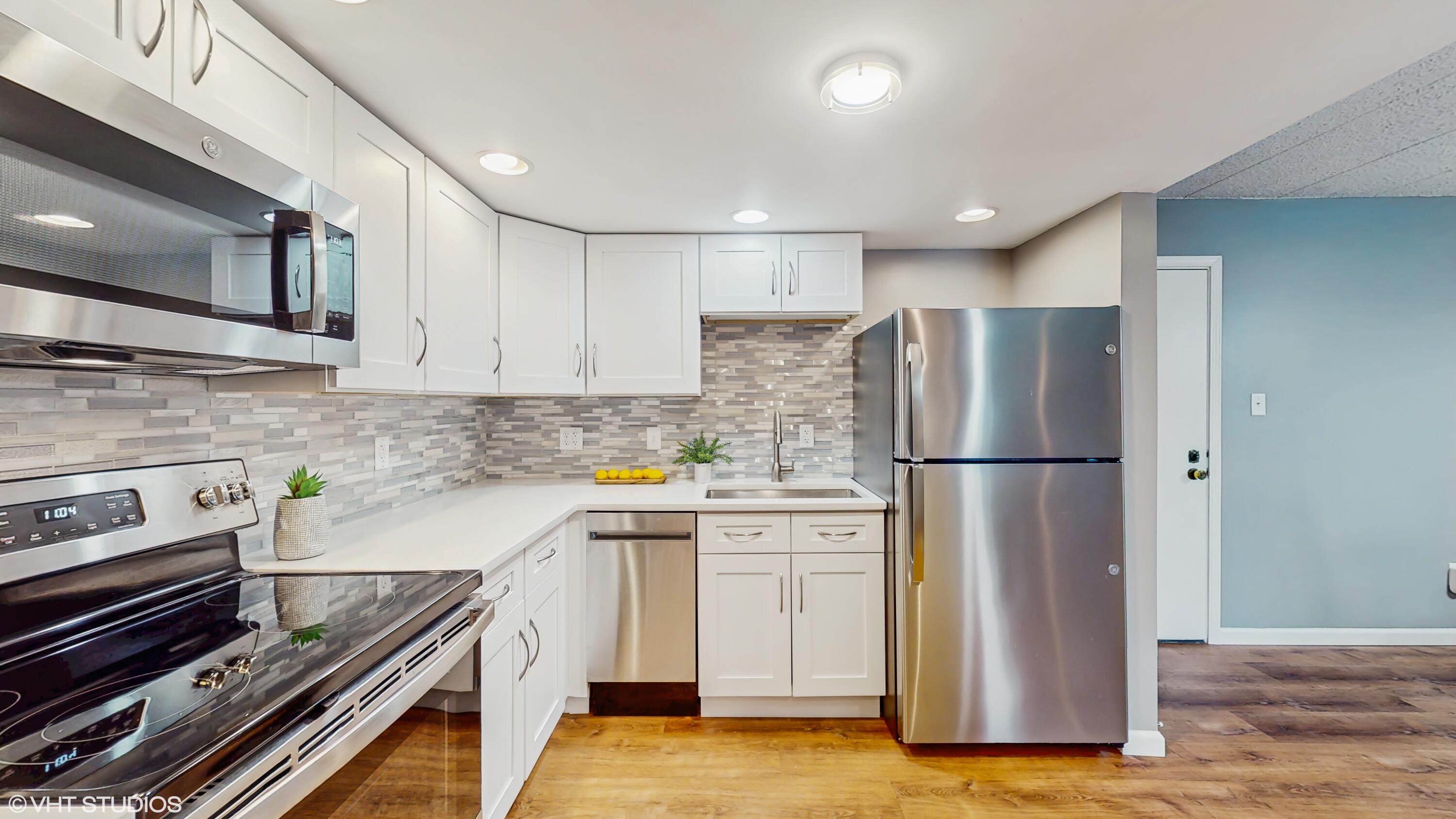 2371 Deerpath Drive, Unit 101 Schererville, IN 46375 - Photo 4 of 13 a kitchen with a refrigerator and a stove top oven
