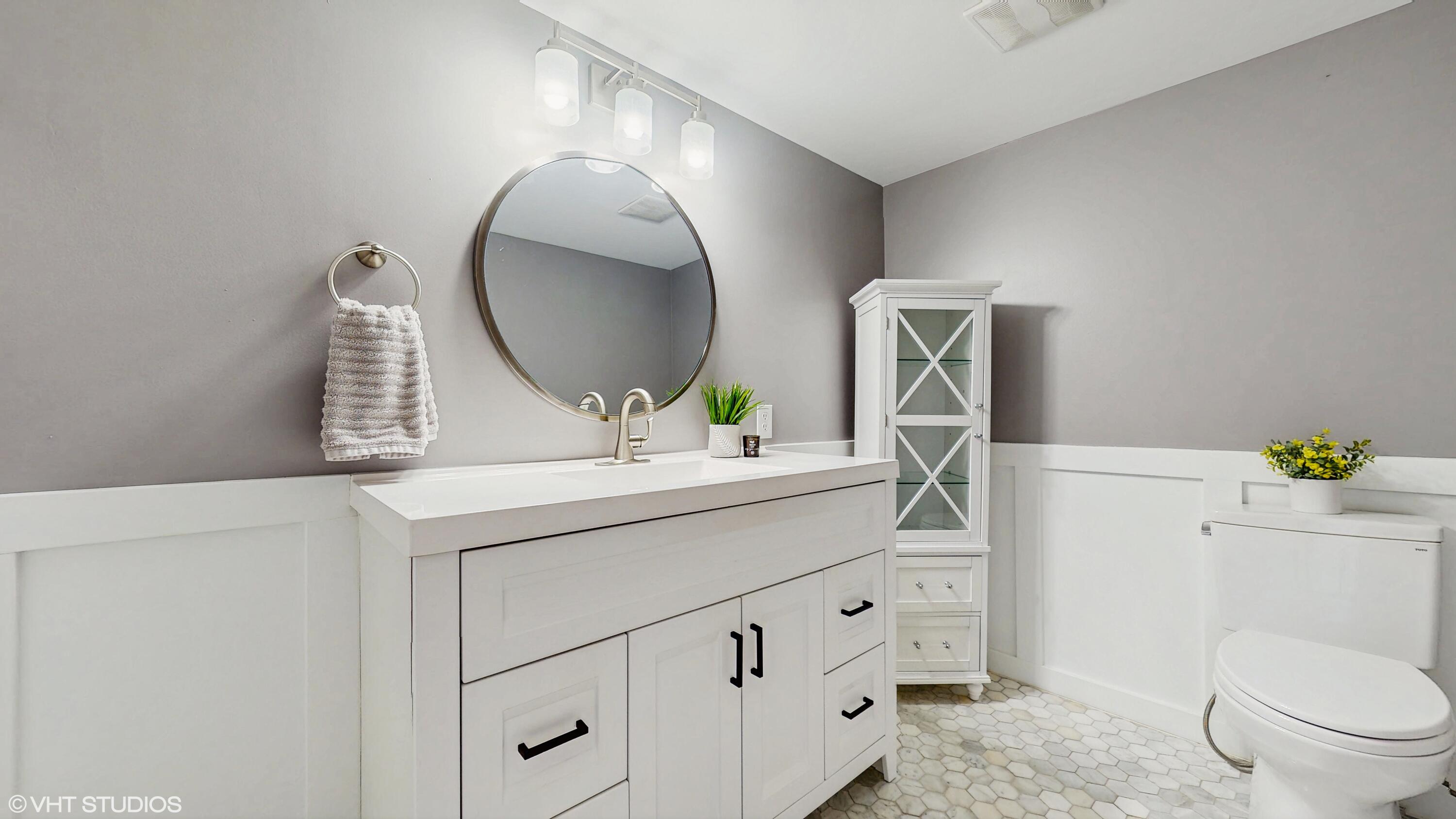 2371 Deerpath Drive, Unit 101 Schererville, IN 46375 - Photo 7 of 13 a bathroom with a toilet sink and mirror