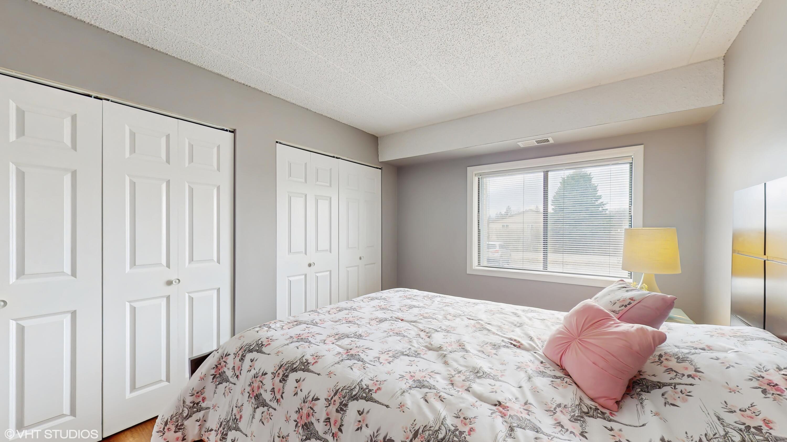 2371 Deerpath Drive, Unit 101 Schererville, IN 46375 - Photo 9 of 13 a bedroom with a bed and a window