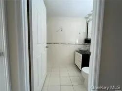 a bathroom with a toilet a sink a mirror and vanity