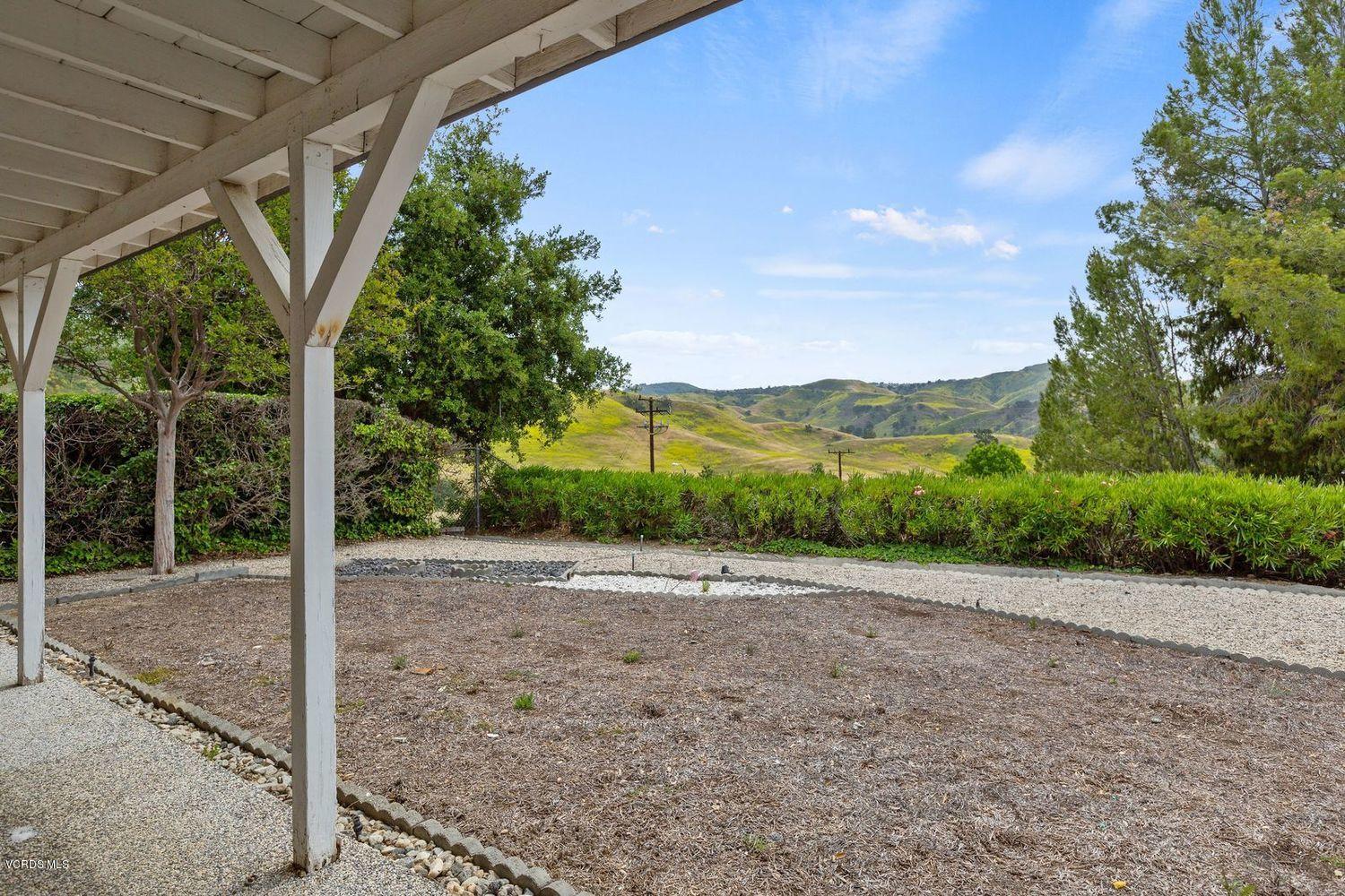 26003 Adamor Road Calabasas, CA 91302 - Photo 14 of 16 a view of a road with a large trees in the background
