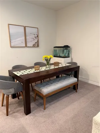 a living room with furniture and paintings on the wall