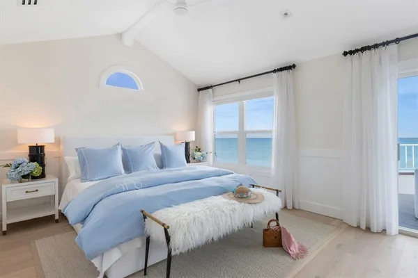 a bedroom with a bed and a large window