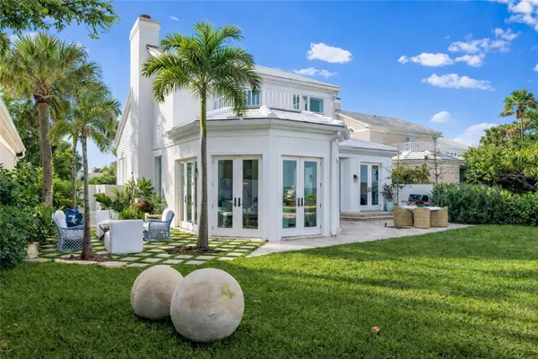 a view of a house with backyard porch and sitting area