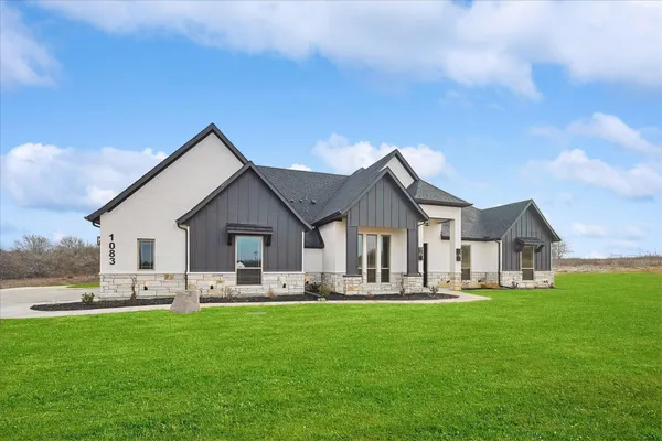 a front view of house with yard and green space