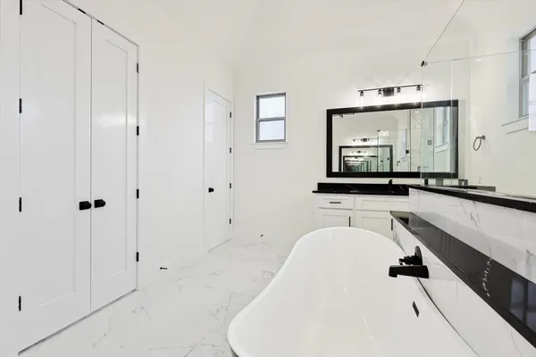a bathroom with a bathtub and a sink