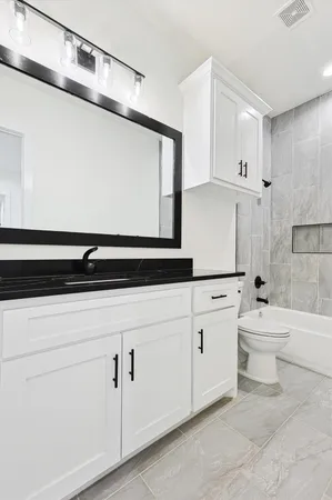 a bathroom with a sink a toilet and a bathtub