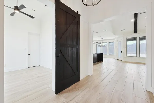 a view of a hallway with wooden floor