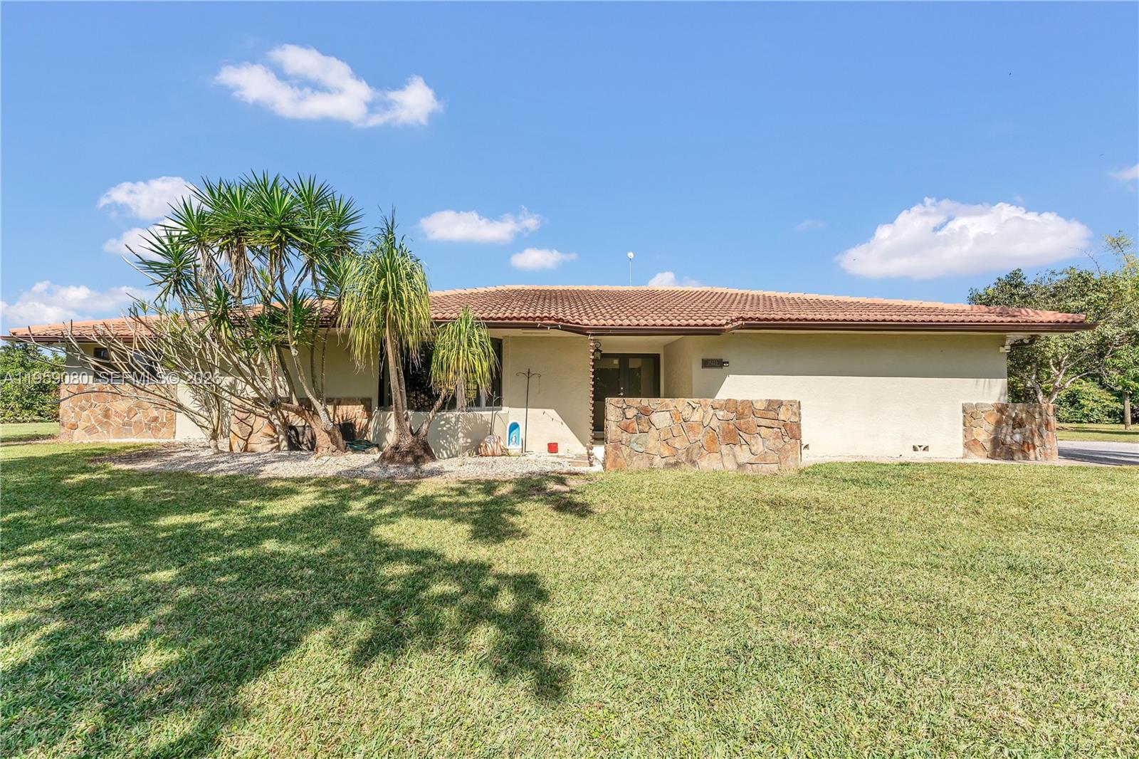 19225 Southwest 186th Street Miami, FL 33187 - Photo 2 of 42 a front view of house with yard