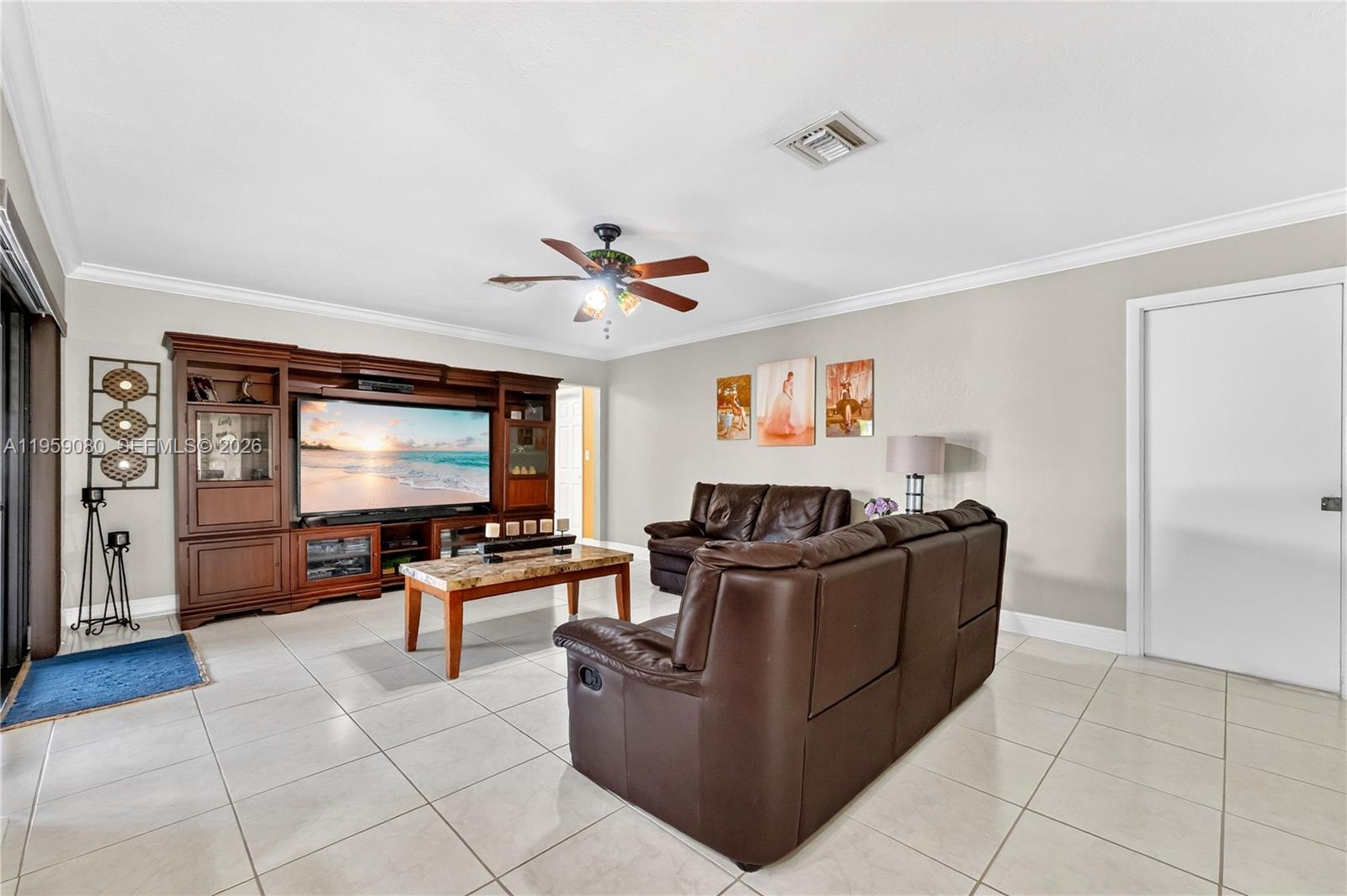 19225 Southwest 186th Street Miami, FL 33187 - Photo 5 of 42 a living room with furniture and a flat screen tv
