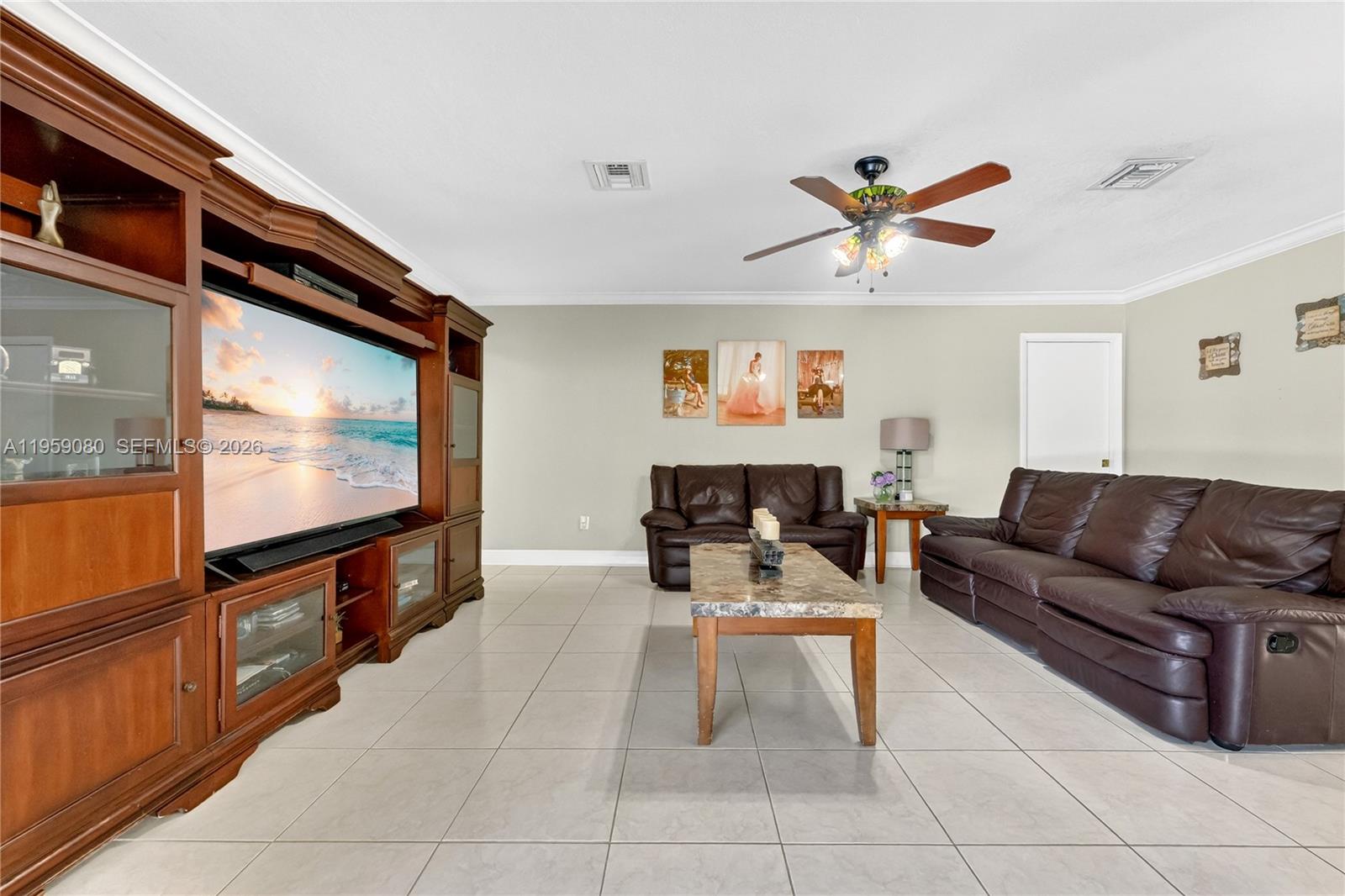 19225 Southwest 186th Street Miami, FL 33187 - Photo 7 of 42 a living room with furniture and a flat screen tv