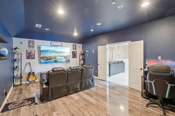 a view of a room with furniture and wooden floor