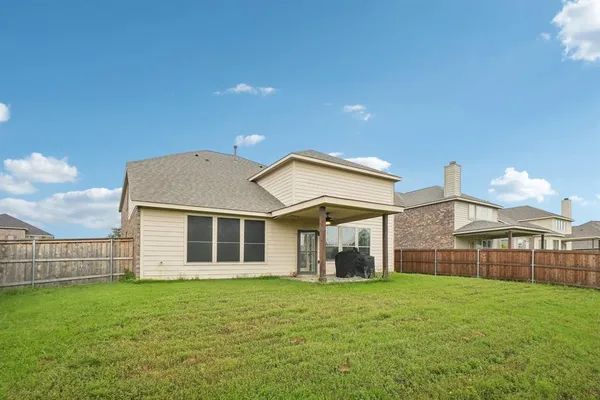 a view of a house with a backyard