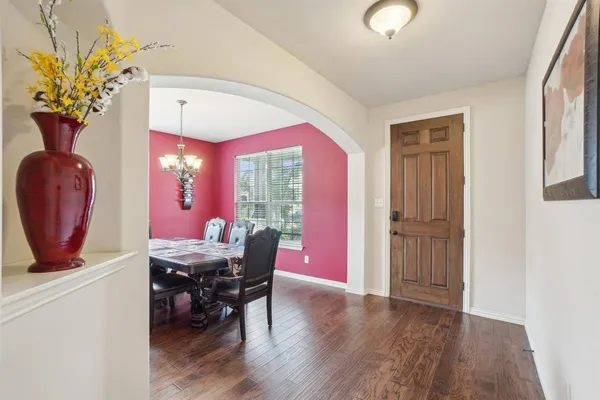 a dining room with furniture and wooden floor