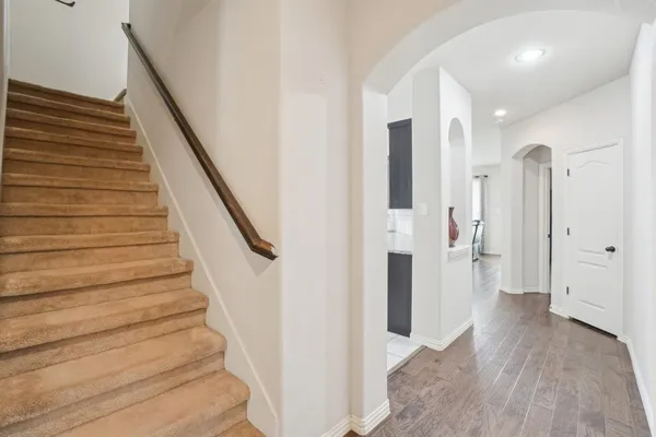a view of entryway with wooden floor and stairs