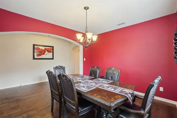 a view of a dining room with furniture and a chandelier