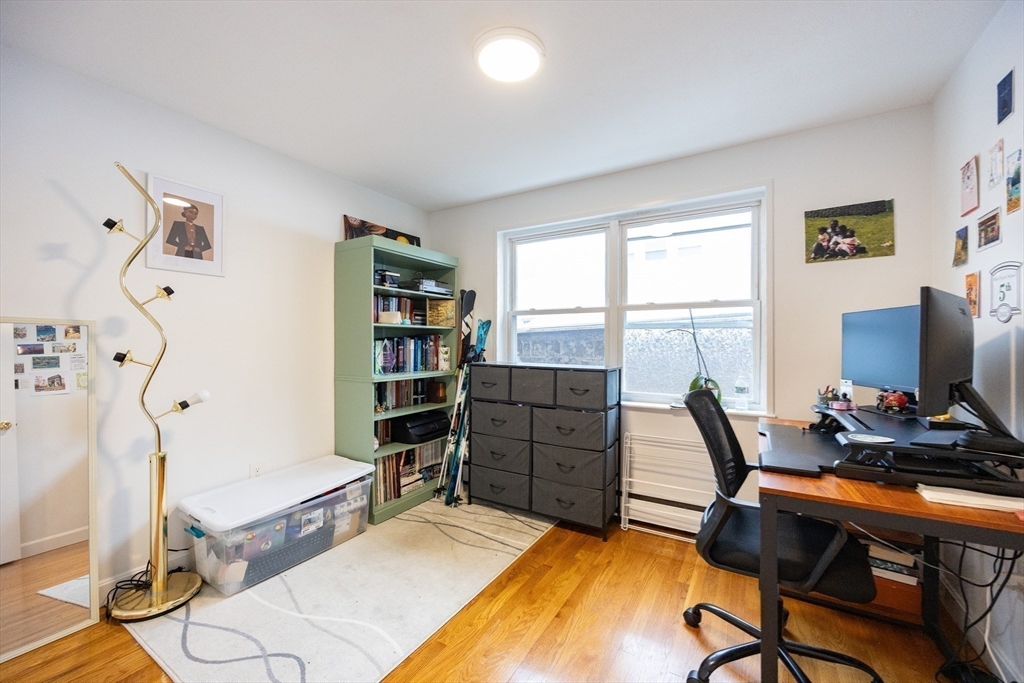 8 Avon Street, Unit 10 Somerville, MA 02143 - Photo 11 of 18 a room with furniture and a wooden floor