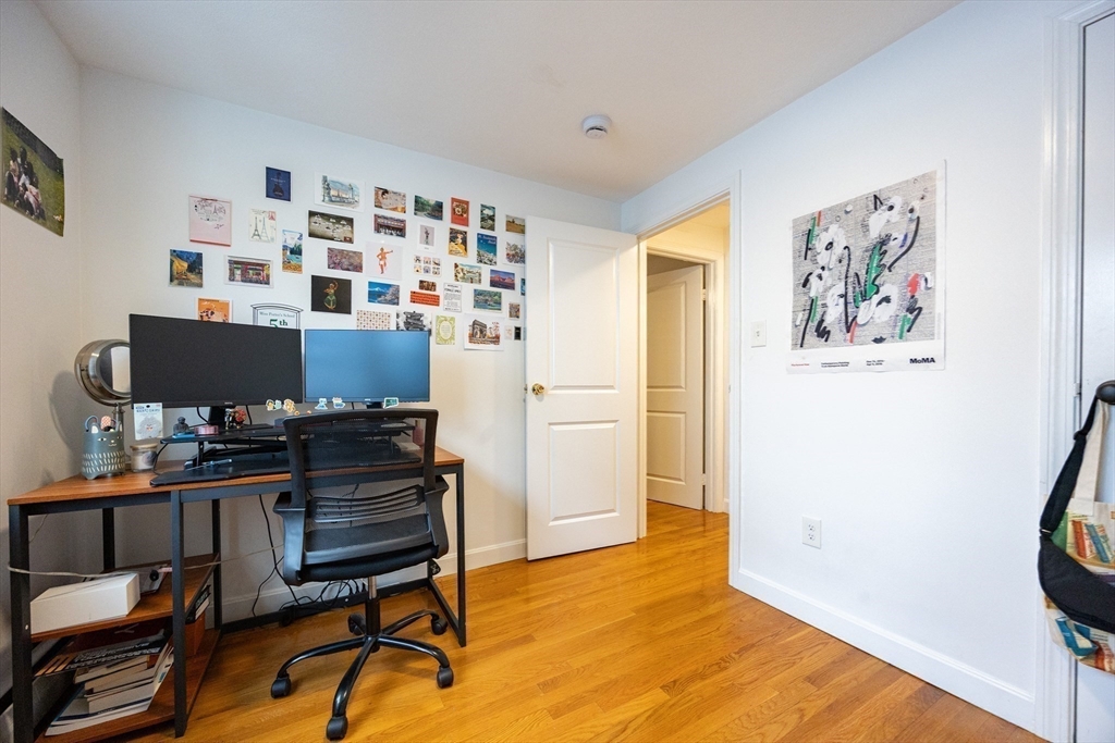 8 Avon Street, Unit 10 Somerville, MA 02143 - Photo 13 of 18 a workspace with furniture and book shelf