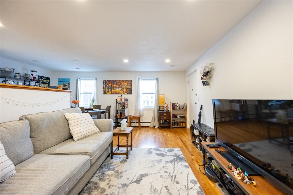 8 Avon Street, Unit 10 Somerville, MA 02143 - Photo 2 of 18 a living room with furniture and a flat screen tv
