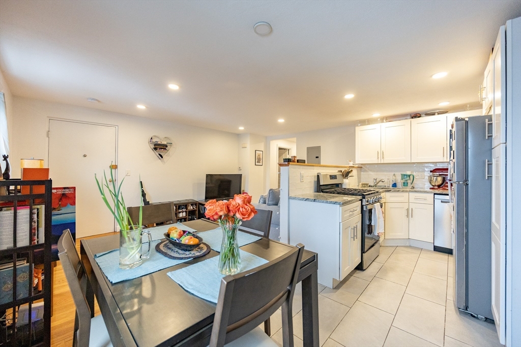 8 Avon Street, Unit 10 Somerville, MA 02143 - Photo 4 of 18 a kitchen with refrigerator and cabinets